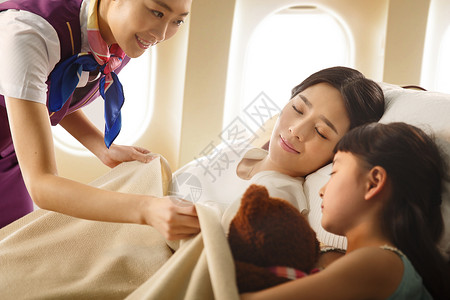 帮孩子盖被子的妈妈乘务员给乘客盖毯子背景