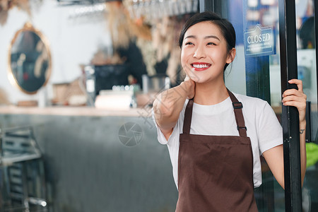 咖啡店门口迎接顾客的女服务员图片