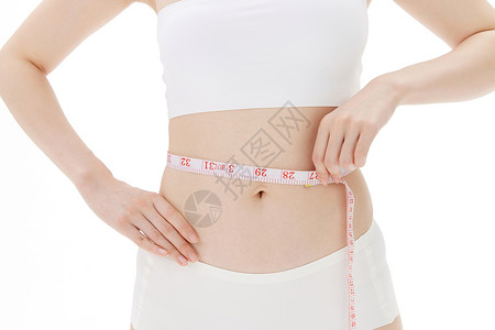 女性卷尺测量腰围尺寸高清图片