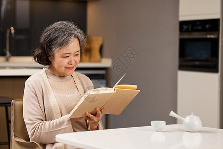 餐桌前看书的老奶奶图片