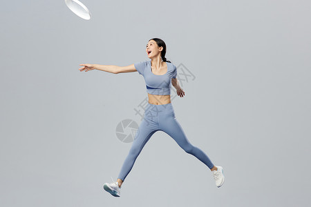 跳起来的女生创意悬浮女性玩飞盘运动背景