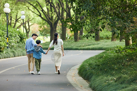 高中生和父母一家人在公园散步背影背景
