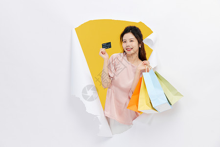 双11预售狂欢购物的青年女性手拿信用卡背景