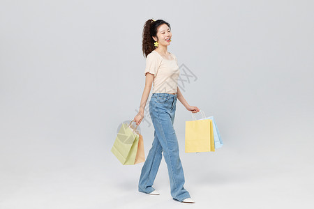 手提购物袋的青年女性背景图片