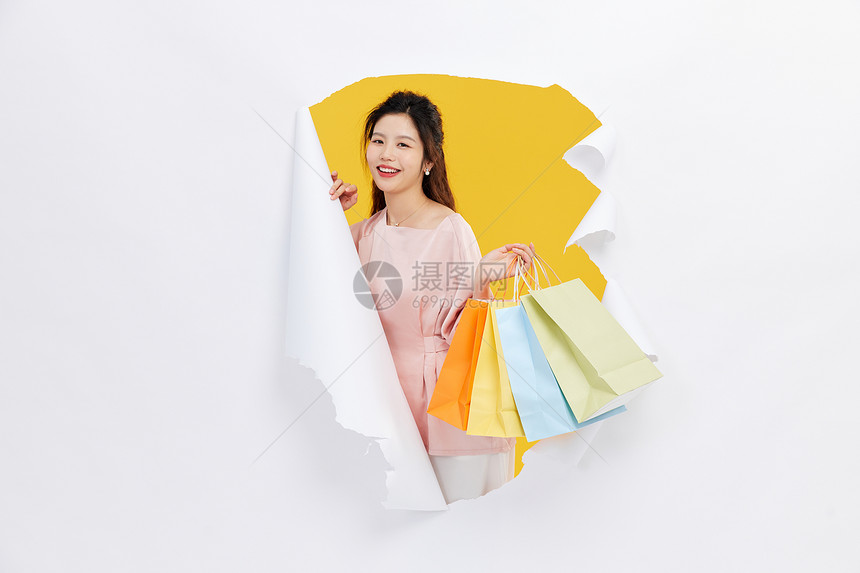 创意女性购物手拿购物袋图片
