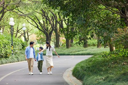 一家人在林荫道路散步图片