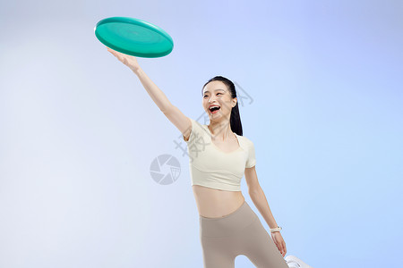 智慧健身投掷飞盘的运动女性背景