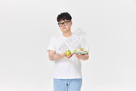 吃水果男孩不爱吃水果蔬菜的肥胖男性背景