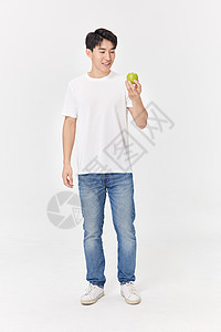 健身男性手拿青苹果图片