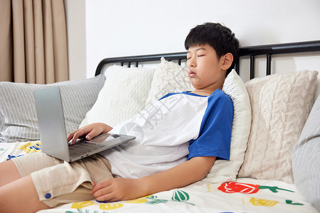 男孩抱着电脑躺在沙发上睡觉背景