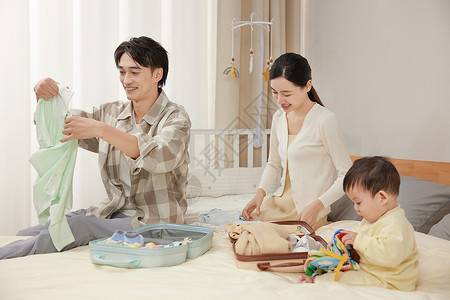 在床上和孩子玩耍的幸福一家三口背景图片