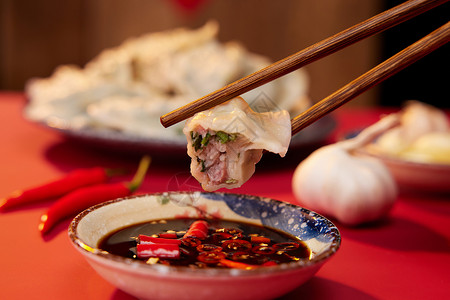 新年文化素材筷子夹起水饺蘸醋特写背景