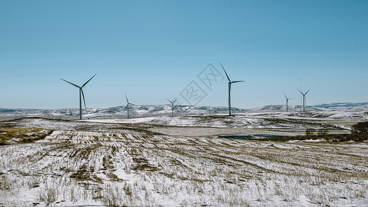 内蒙古冬季农田冰雪风力发电背景图片