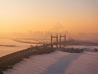 冬天日出航拍黑龙江哈尔滨阳明滩大桥日出背景