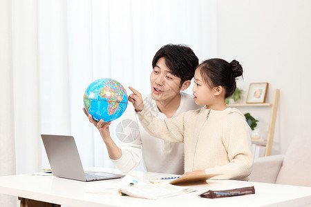 地理教学素材拿着地球仪的爸爸正温柔给女儿讲解地理知识背景