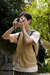 相机人帅气小伙在山上用相机拍山景背景