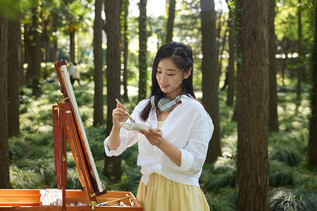 写生素材站着在花架上画画的美女背景