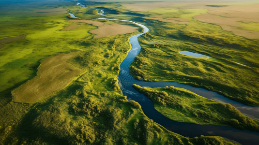黄色一条河流横穿被草地环绕的土地高清图片