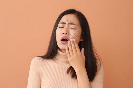 女人把手放在疼痛的嘴角边高清图片