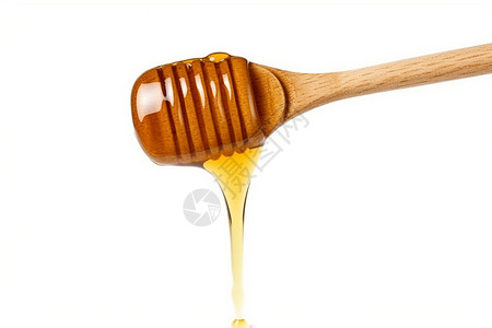 蜂蜜滴从勺子上低落图片