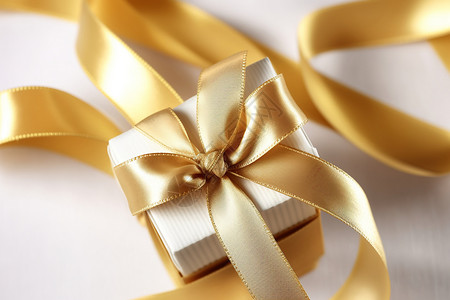金色装饰丝带绑着丝绸带的礼物盒设计图片