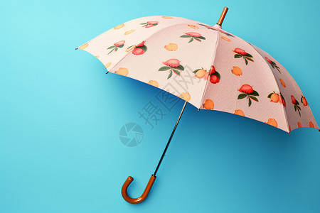 蓝色背景前的一把雨伞背景图片