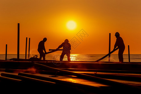 船日落黎明海边日落工作的工人设计图片