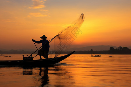 黄昏撒网的渔夫背景图片