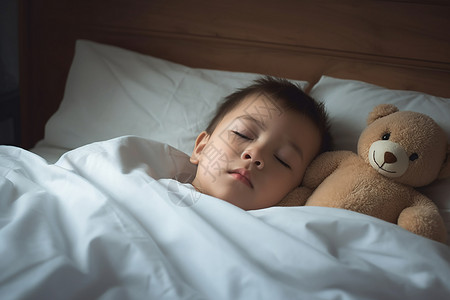床上睡觉的小男孩高清图片