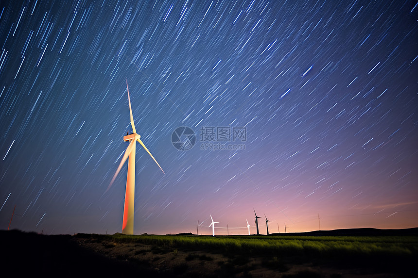 夜晚星空下的风力涡轮机图片