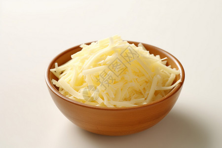 木碗中香甜的奶酪丝图片