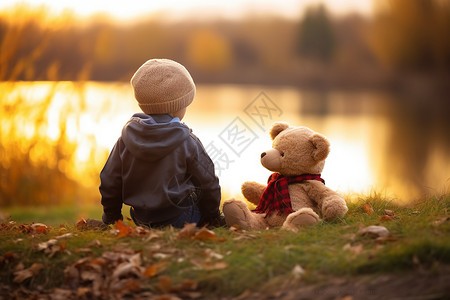 玩耍熊河边的小男孩和玩具熊背景
