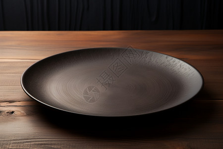 圆形磨砂的黑色陶瓷餐具背景图片