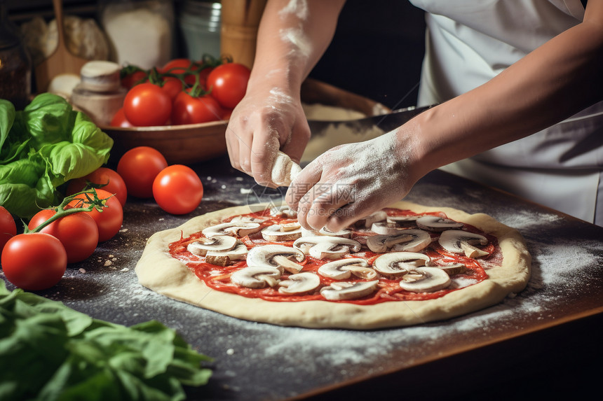 厨房中制作披萨的厨师图片