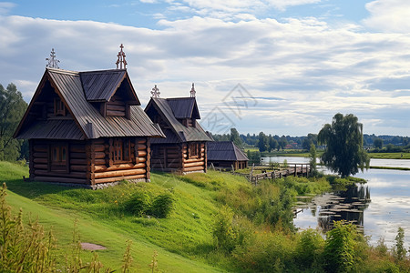 一座木屋坐落在湖边的草坡上图片