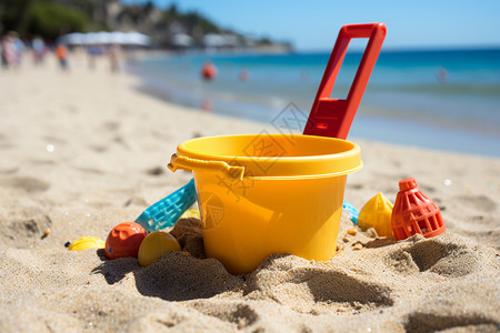 黄色铲子玩具沙滩上的桶和铲子背景