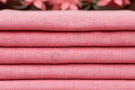 叠放的粉色棉麻布料背景图片