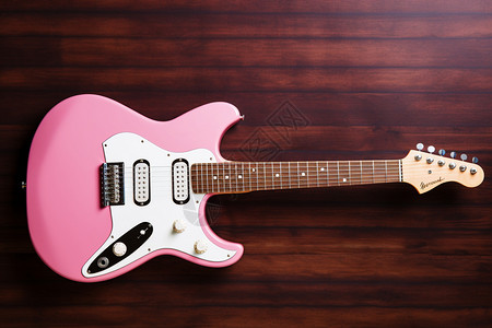 木桌上的粉色吉他图片