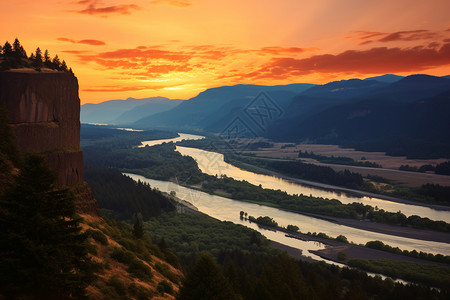 河山落日下的河谷背景图片
