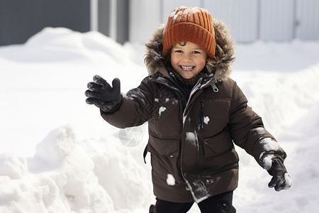 小男孩在雪地里打雪仗背景图片