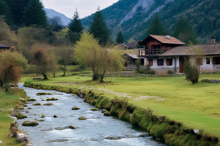 山谷中的房屋建筑和河流背景图片