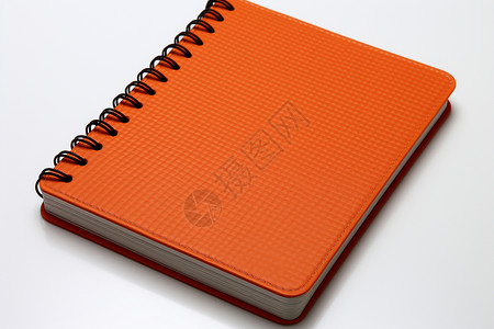桌面上的橘色笔记本背景图片