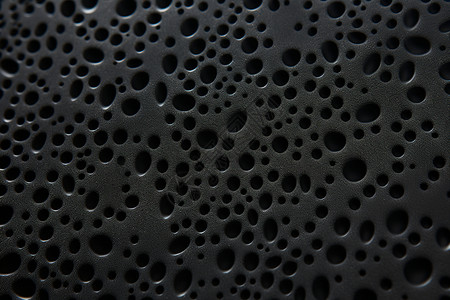 黑色海绵黑色橡胶壁纸里的小洞背景