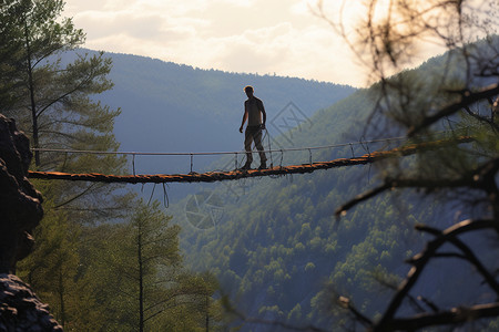 山间高空悬索桥上的男人图片