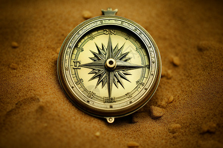 沙丘中的黄铜指南针图片