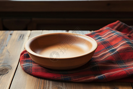 木桌上的碗和布料背景图片