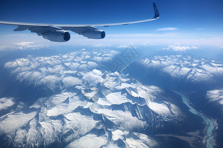 辽阔雪山山脉上空的飞机设计图片