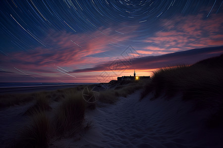 夜晚海滩上的星轨背景图片