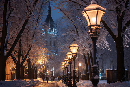 夜晚雪地里的街灯和教堂高清图片