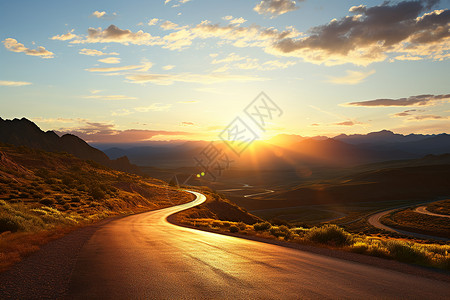 夕阳下穿越山谷的公路背景图片